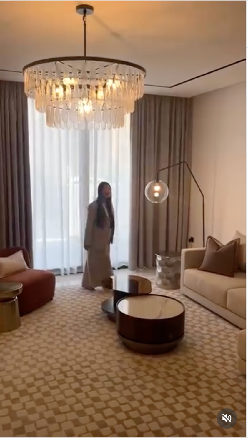 Living room with chandelier, curtains, coffee table and warm seating