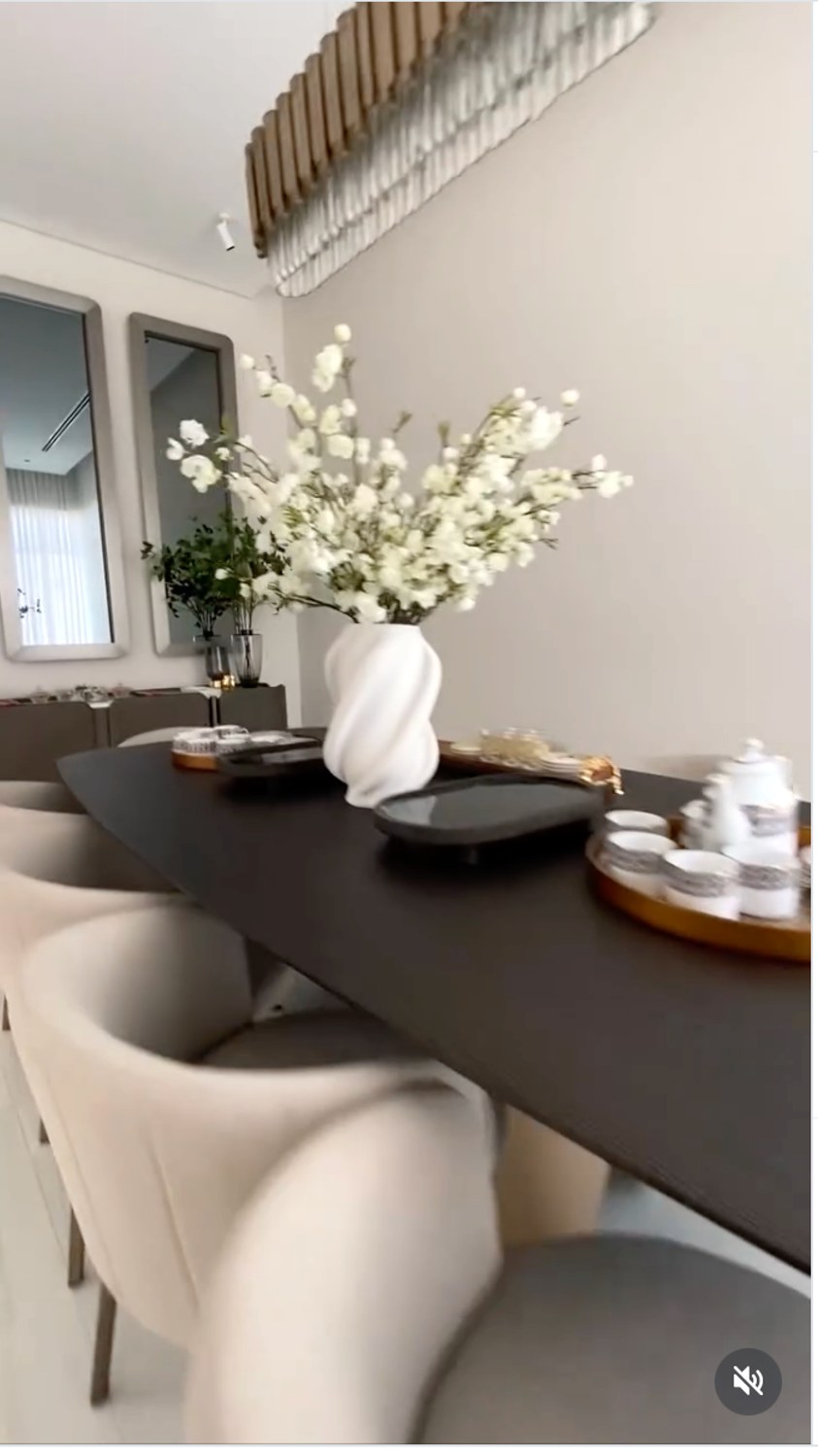 Villa dining area with flowers, tableware and soft neutral styling